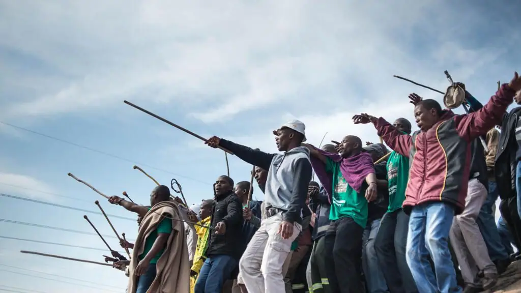 Miners dance during commemorations to mark the fourth anniversary of the Marikana Massacre in Rustenburg on August 16, 2016